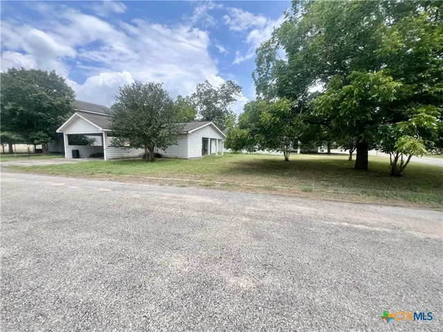 a living room with furniture and book shelf