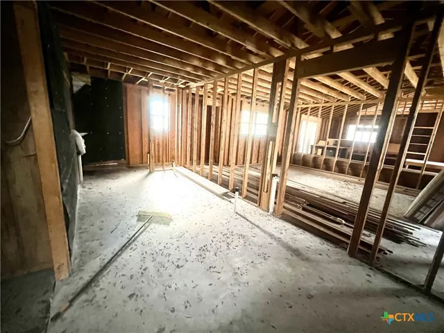 a view of a livingroom with an empty space and a window