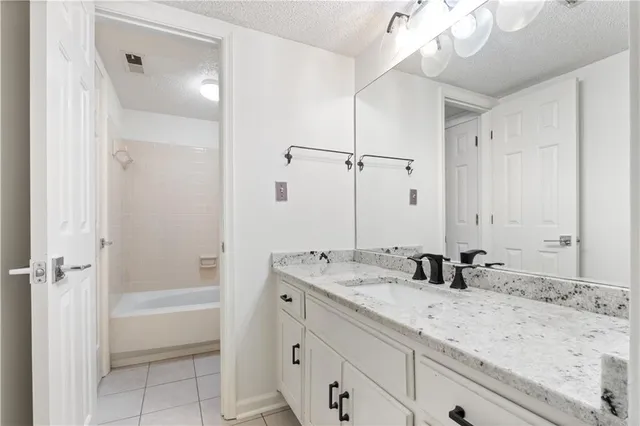 a bathroom with a tub sink and mirror