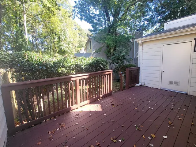 a view of a deck with wooden floor and fence