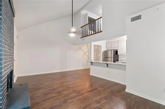 a view of a kitchen with furniture and wooden floor