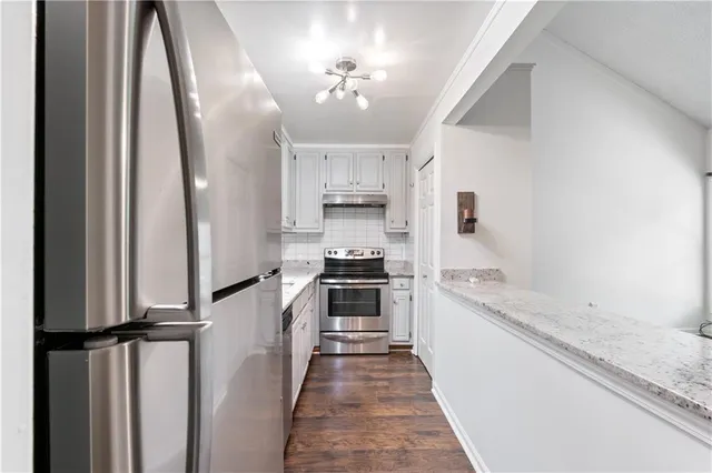 a kitchen with a stove a sink and a refrigerator
