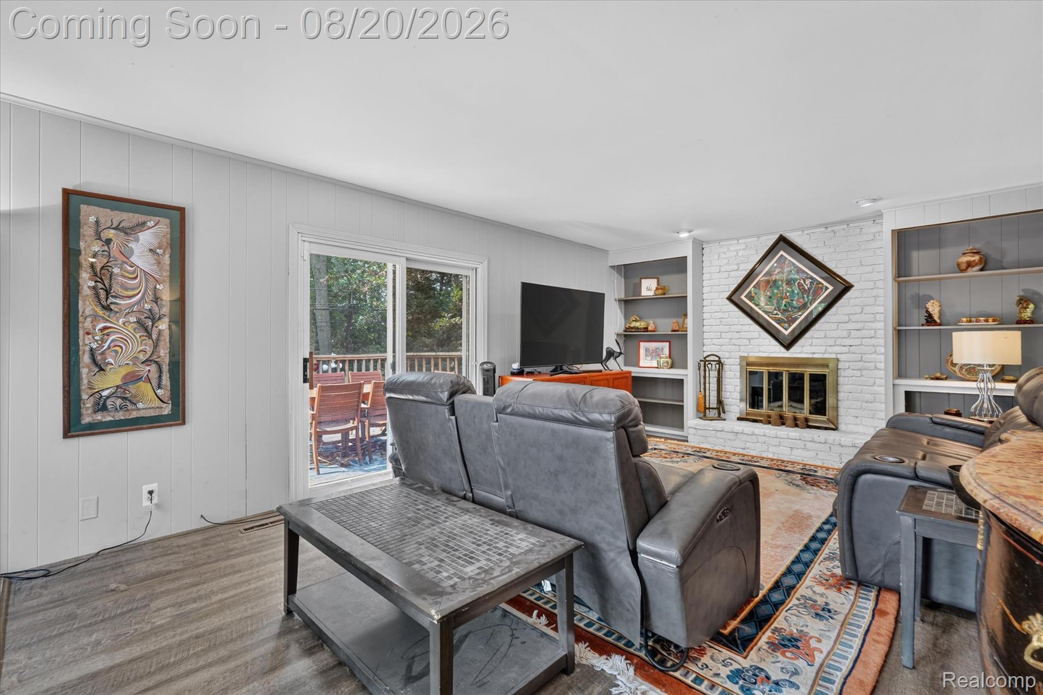 6235 Waldon Road Clarkston, MI 48346 - Photo 11 of 41 Living area with wood-finish flooring and white vertical paneling