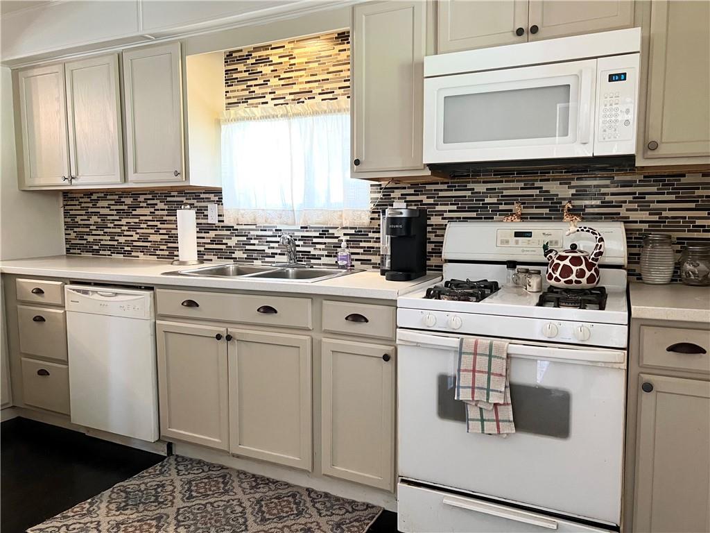 Updated kitchen with hardwood flooring.