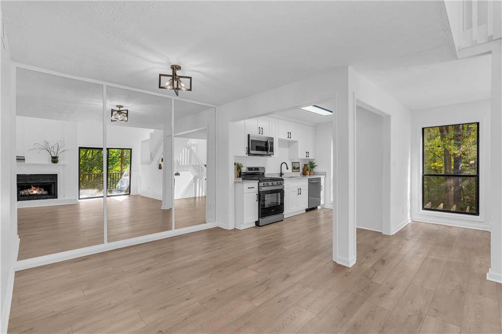 a view of kitchen with cabinets and wooden floor