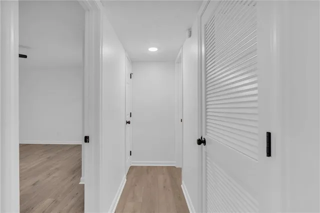 a view of a hallway with wooden floor