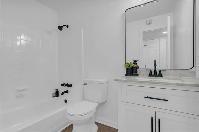 a bathroom with a bathtub a sink a toilet and a mirror