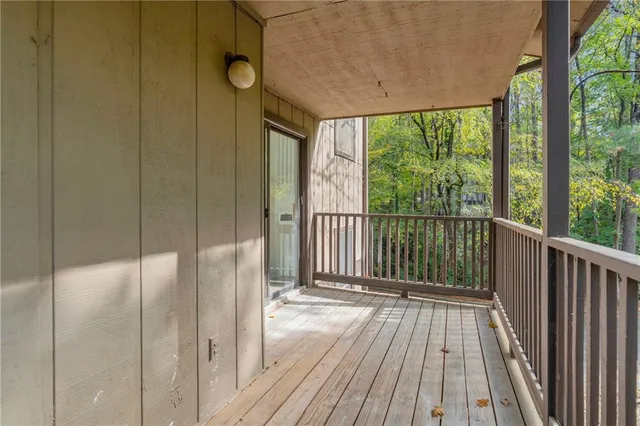 a view of a balcony with wooden floor