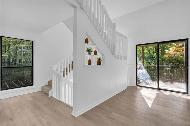 a view of a hallway with windows and plants