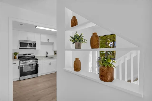 a kitchen with a sink and appliances