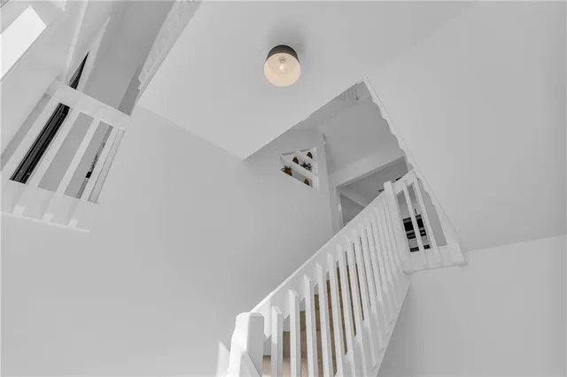 a view of staircase with rug