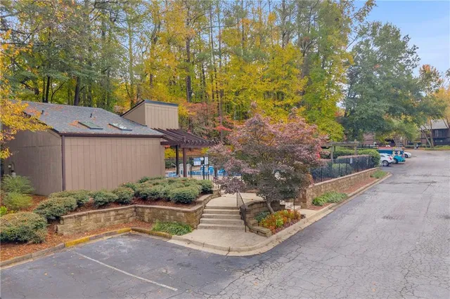 a view of a yard with plants and a fountain