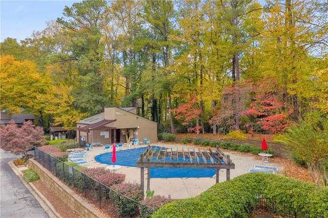 a view of a house with swimming pool and sitting area