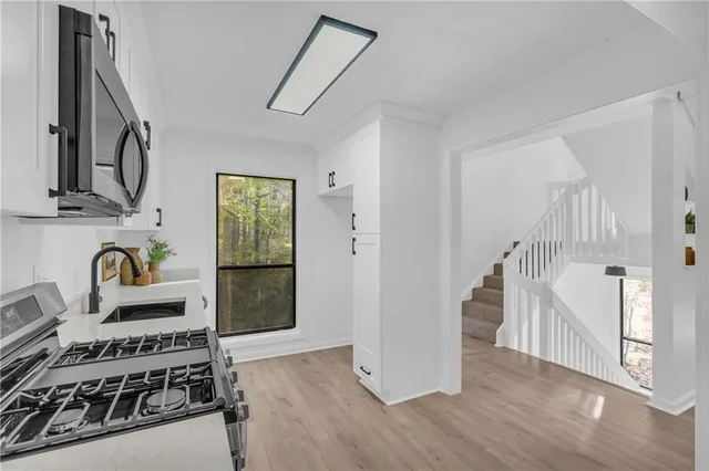 a view of a kitchen with a stove top oven