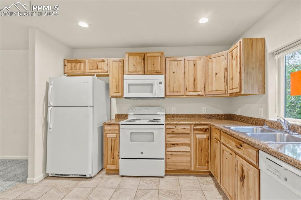 6010 Oak Street Rye, CO 81069 - Photo 5 of 29 a kitchen with white cabinets and white appliances