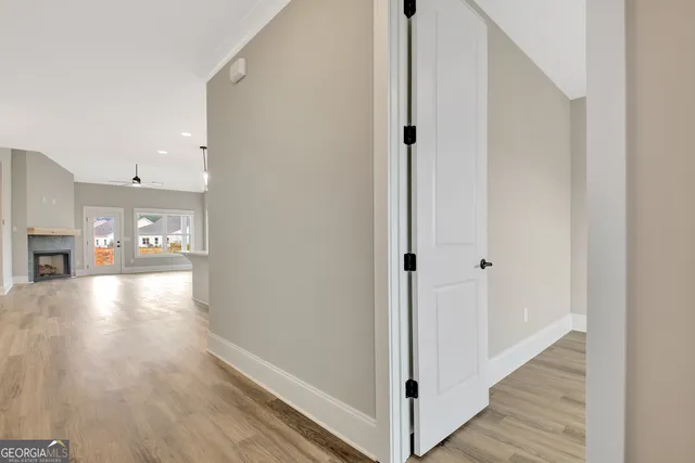 a view of a room with wooden floor