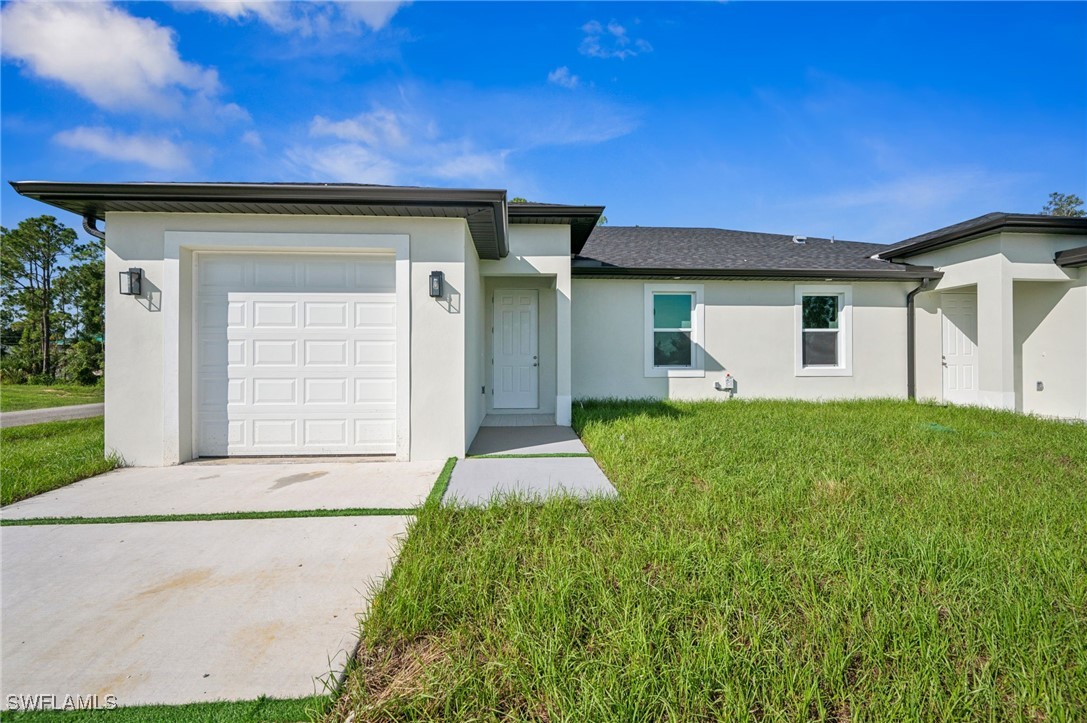 a front view of a house with a yard and garage