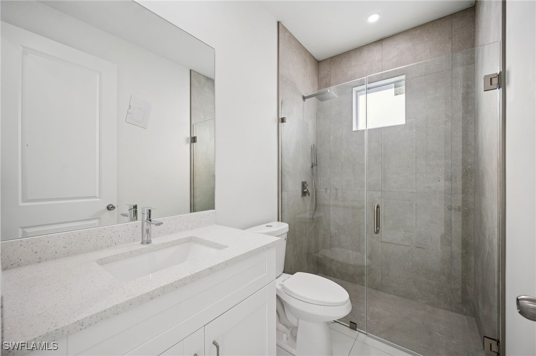 4701-4703 28th Street Southwest Lehigh Acres, FL 33973 - Photo 15 of 37 a bathroom with a sink a toilet and shower