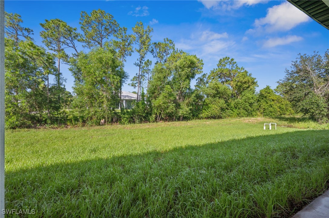 4701-4703 28th Street Southwest Lehigh Acres, FL 33973 - Photo 22 of 37 a view of a garden with a building in the background