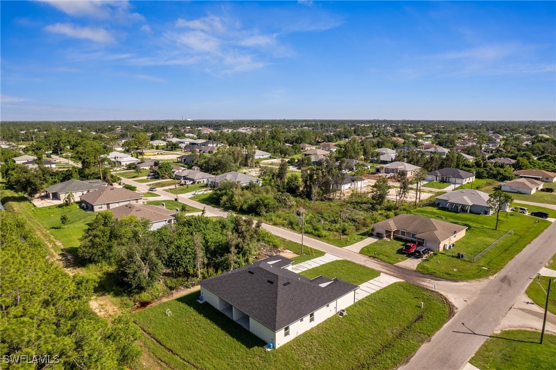 4701-4703 28th Street Southwest Lehigh Acres, FL 33973 - Photo 27 of 37 an aerial view of residential houses with outdoor space and trees