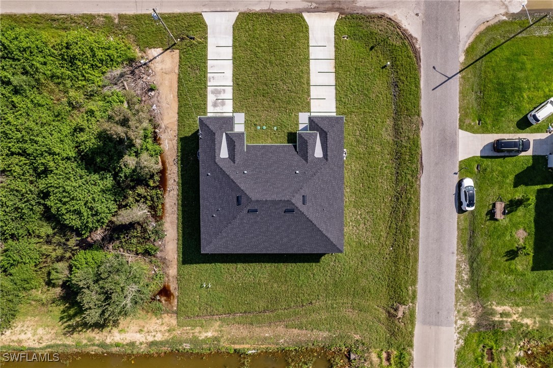 4701-4703 28th Street Southwest Lehigh Acres, FL 33973 - Photo 30 of 37 an aerial view of a residential houses with yard