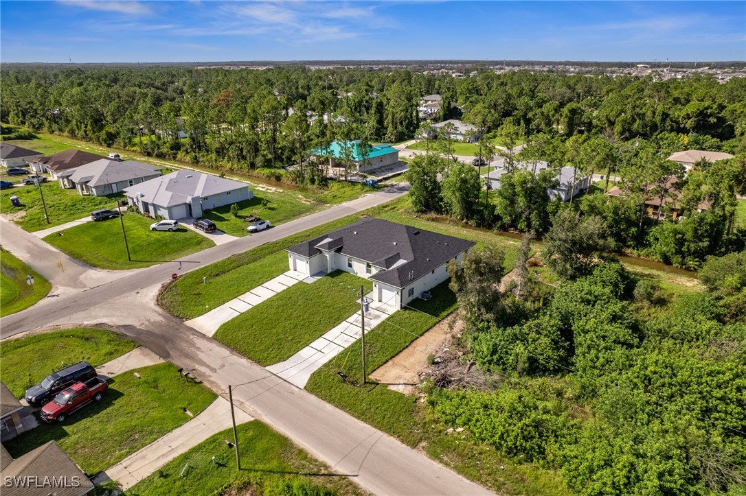 4701-4703 28th Street Southwest Lehigh Acres, FL 33973 - Photo 32 of 37 a view of a city and lush green forest