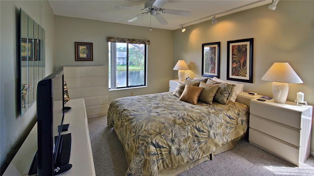 928 South Pine Ridge Circle Sanford, FL 32773 - Photo 12 of 22 a bedroom with a bed and a chandelier
