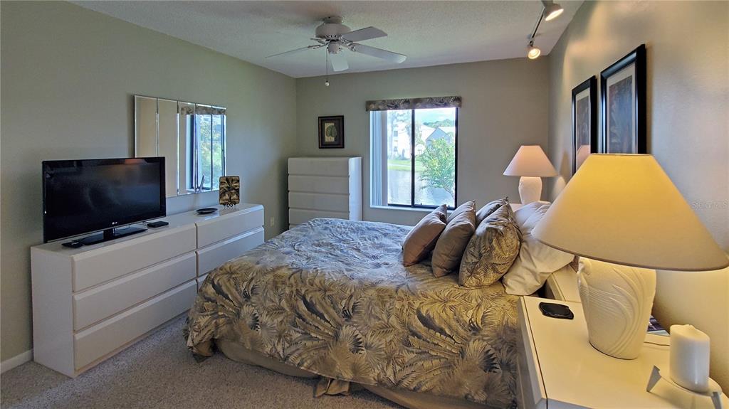 928 South Pine Ridge Circle Sanford, FL 32773 - Photo 13 of 22 a bedroom with a bed and a flat screen tv