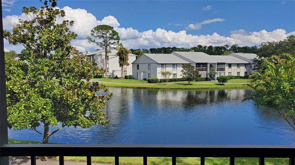 928 South Pine Ridge Circle Sanford, FL 32773 - Photo 5 of 22 a view of a lake with a building in the background