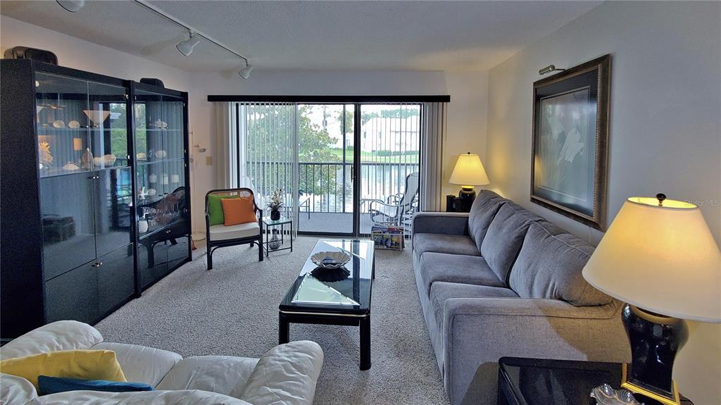 928 South Pine Ridge Circle Sanford, FL 32773 - Photo 6 of 22 a living room with furniture and a lamp