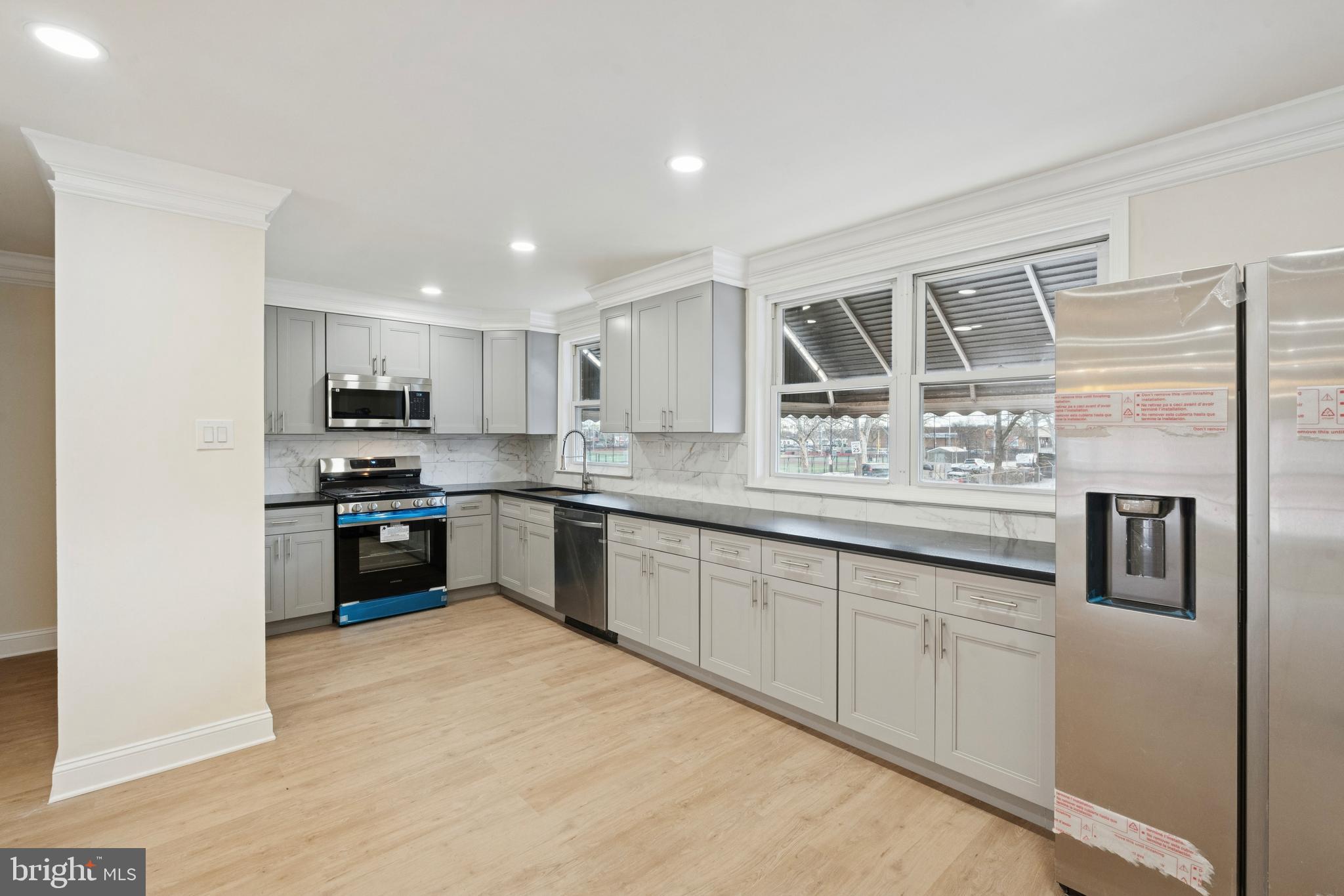 411 West Shunk Street Philadelphia, PA 19148 - Photo 1 of 25 a kitchen with stainless steel appliances granite countertop a refrigerator a sink a stove and oven