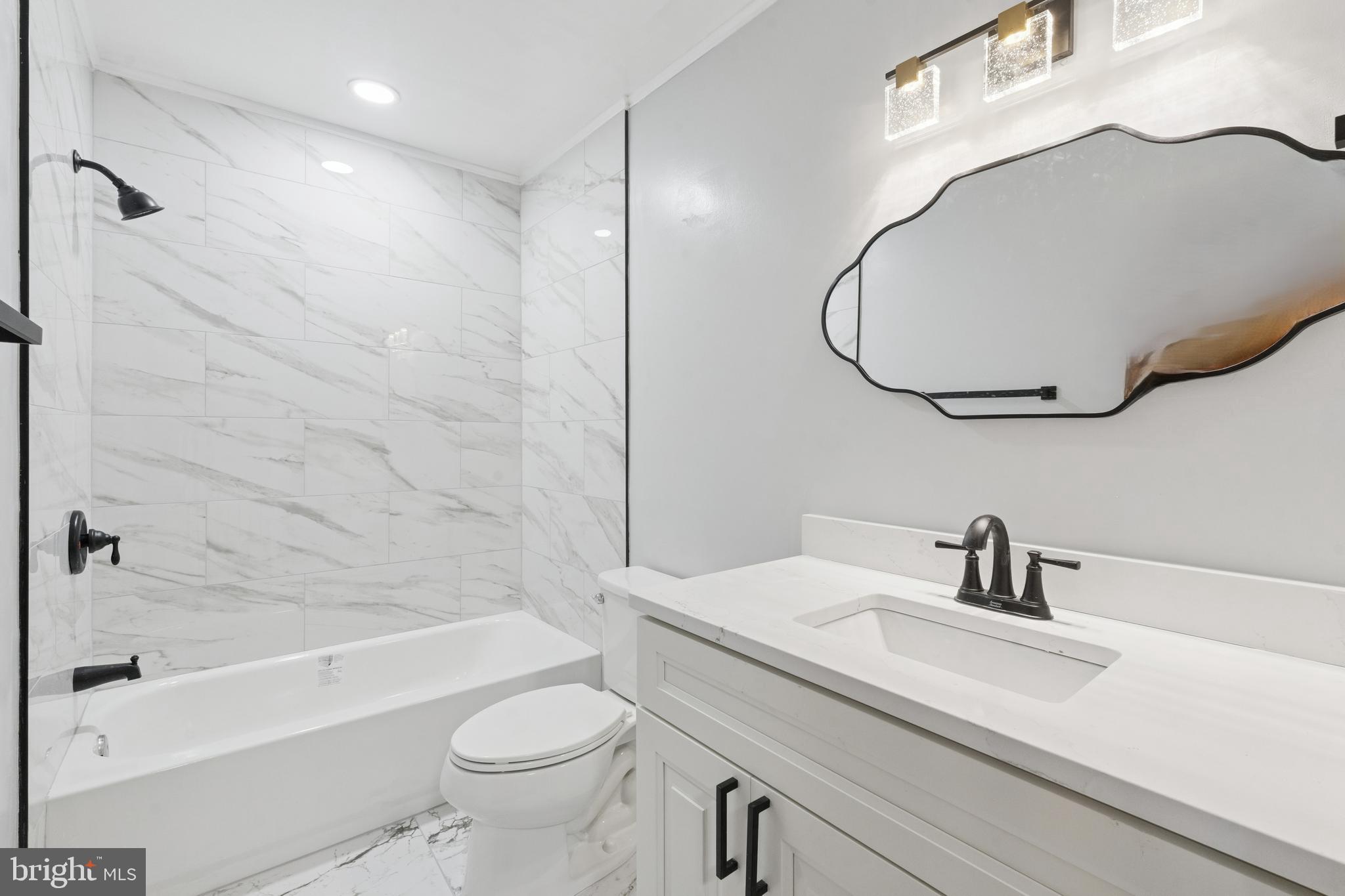 411 West Shunk Street Philadelphia, PA 19148 - Photo 22 of 25 a bathroom with a sink a toilet and a mirror