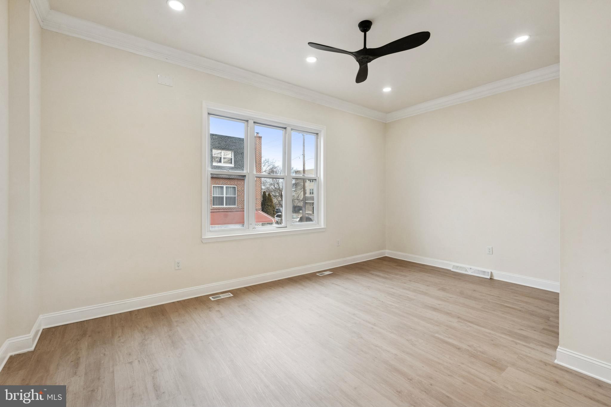 411 West Shunk Street Philadelphia, PA 19148 - Photo 10 of 25 an empty room with wooden floor ceiling fan and windows