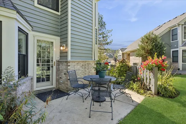a view of a house with backyard sitting area and garden