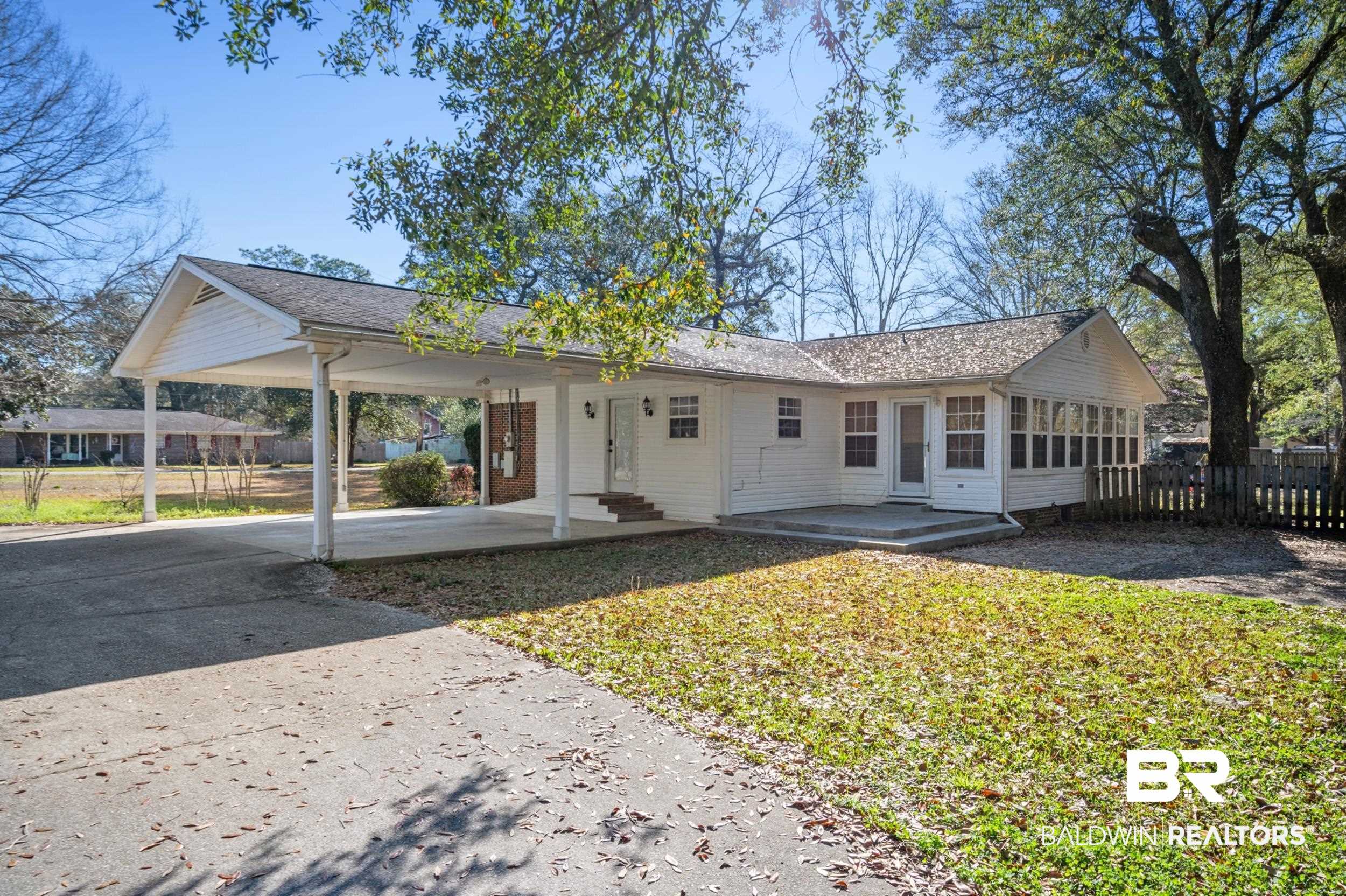 809 Moog Avenue Bay Minette, AL 36507 - Photo 5 of 33 View of front of property with a carport, a patio area, a sunroom, and driveway