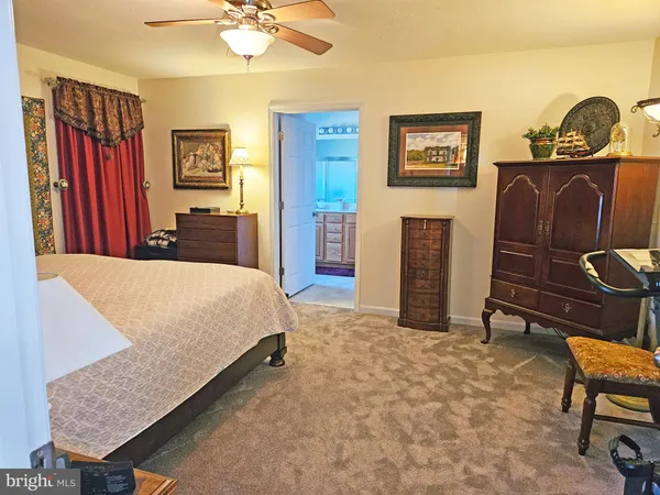 a bedroom with a bed and a dresser in it