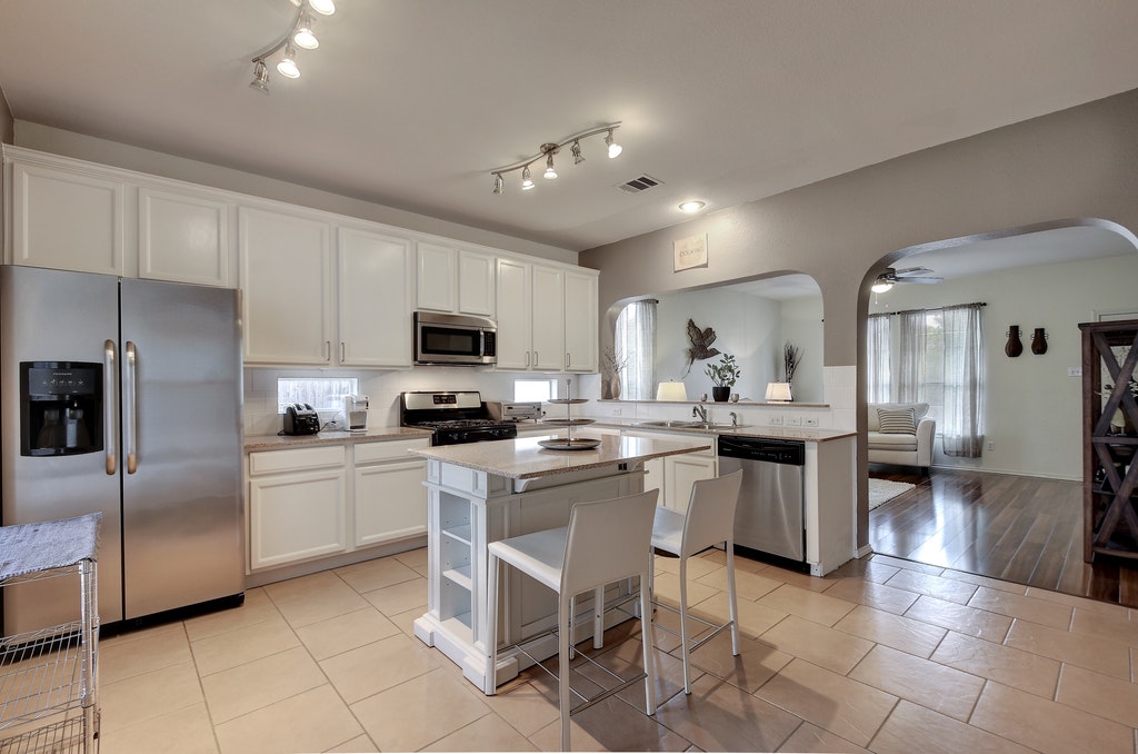 2201 Keepsake Drive Austin, TX 78745 - Photo 8 of 25 a kitchen with a sink stainless steel appliances and cabinets