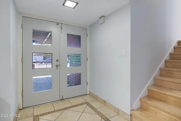 a view of a kitchen with a sink and an empty room