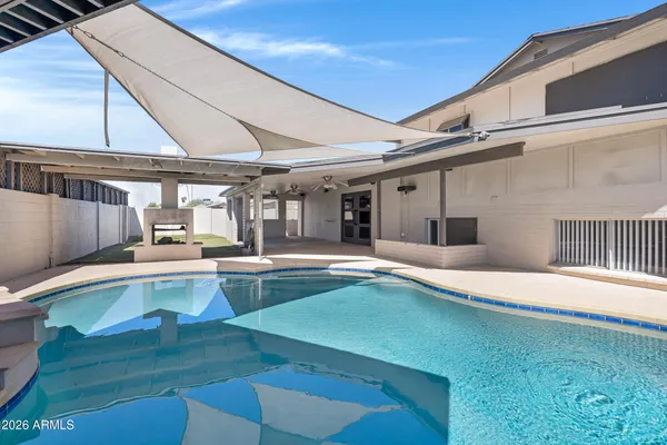 a swimming pool with outdoor seating and yard