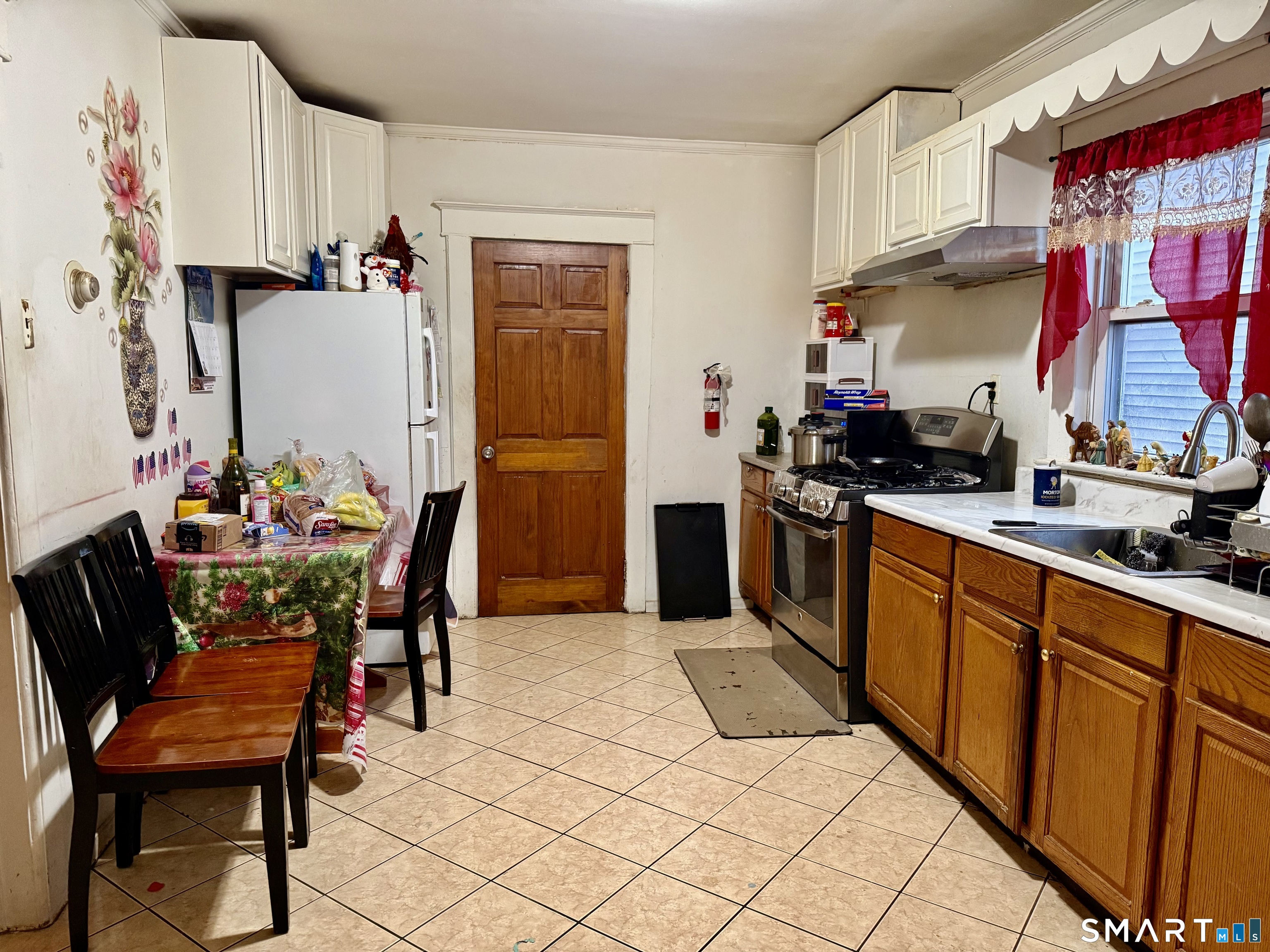 60 Stephen Street Stamford, CT 06902 - Photo 17 of 29 1st Fl Eat-In Kitchen with some new appliances-New Gas Stove, New Hood, New Sink, Etc.,
