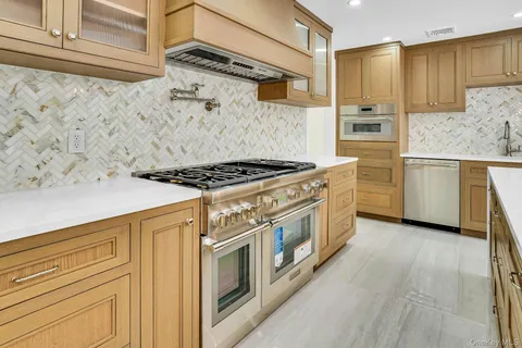 a kitchen with stainless steel appliances granite countertop a stove and a refrigerator