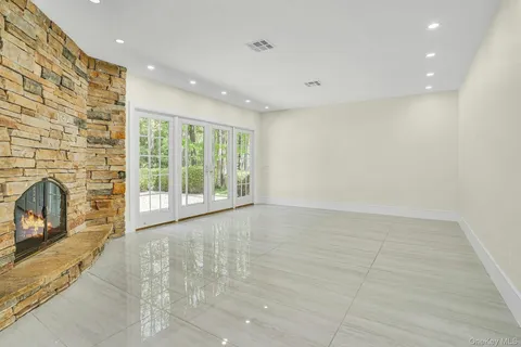 a view of an empty room with a fireplace