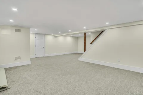 an empty room with a projector space and windows