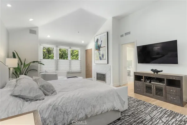 a bedroom with a bed and a flat screen tv