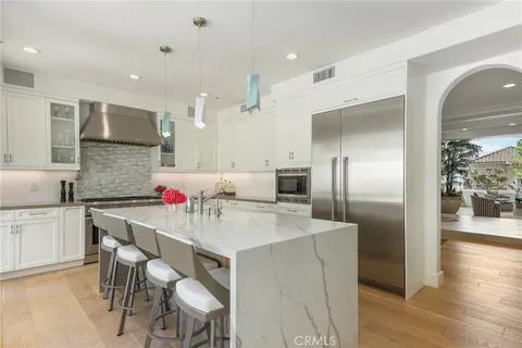 a large kitchen with a table and chairs