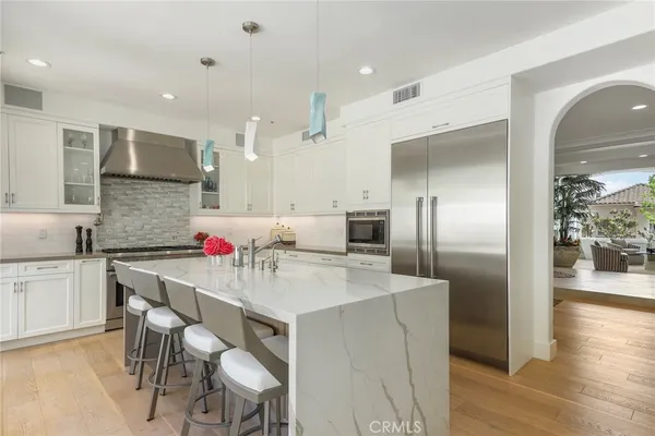 a large kitchen with a table and chairs