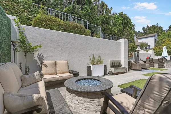 a backyard of a house with barbeque oven and outdoor seating