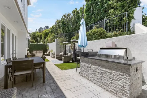 a view of a patio with couches chairs and a potted plant