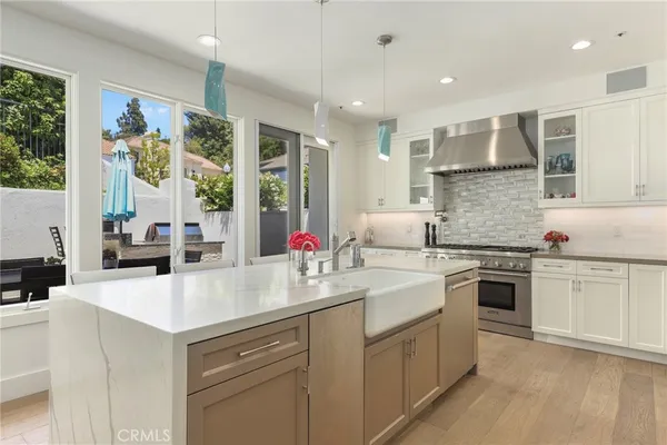 a kitchen with stainless steel appliances granite countertop a lot of counter space and a sink
