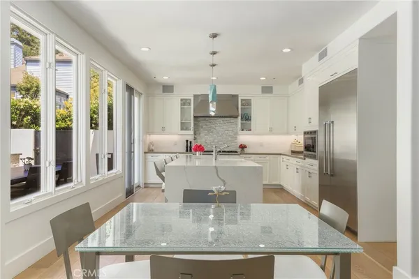 a kitchen with kitchen island a counter top space cabinets and stainless steel appliances